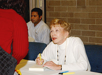 Sonia Pressman Fuentes speaks with students while signing her book.